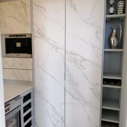 Aluminum pantry cabinets in grey and including doors in Neolith