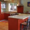 brick red, glass uppers, recycled glass countertop olive colour, red backsplash